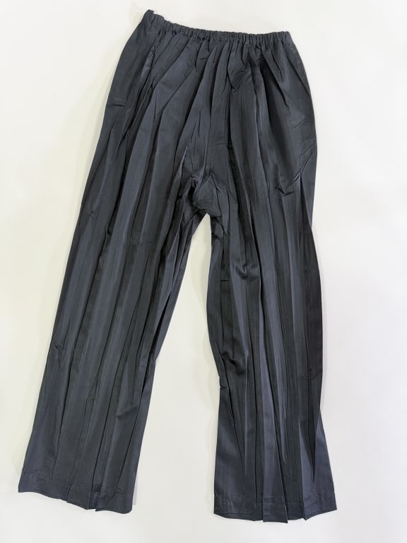 Vintage 1990s Issey Miyake Pleated Satin Trousers: Vintage 1990s Issey Miyake Pleated Satin Trousers having elastic waist with side zip closure and single side pocket. Labeled Issey Miyake Bergdorf Goodman, marked size small. Measuring 24-38 inch wais