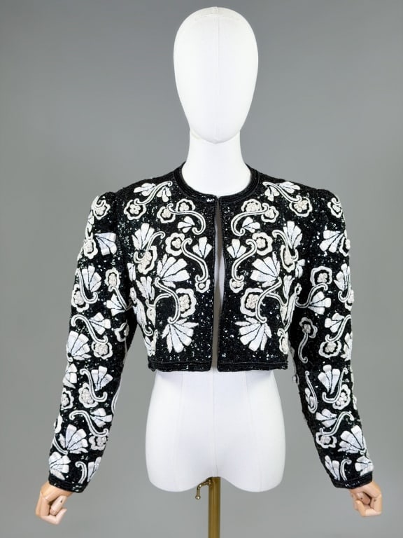 Vintage 1980s Cropped Beaded Floral Ribbon Jacket: Vintage 1980s Cropped Beaded Floral Ribbon Jacket having sequin bead and floral ribbon details throughout. Closing at neck with hook, fully lined. Measuring 40 inch bust, 15 inches long, 24 inch sleev