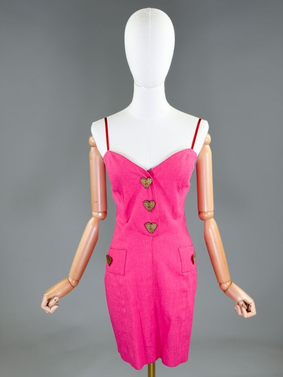 Vintage 1980s Zang Toi Denim Heart Dress: Vintage 1980s Zang Toi Denim Heart Dress having boned bodice with metal heart button detail at front, two front patch pockets and center back zip closure. Labeled Zang Toi, marked size 8. Measuring 32