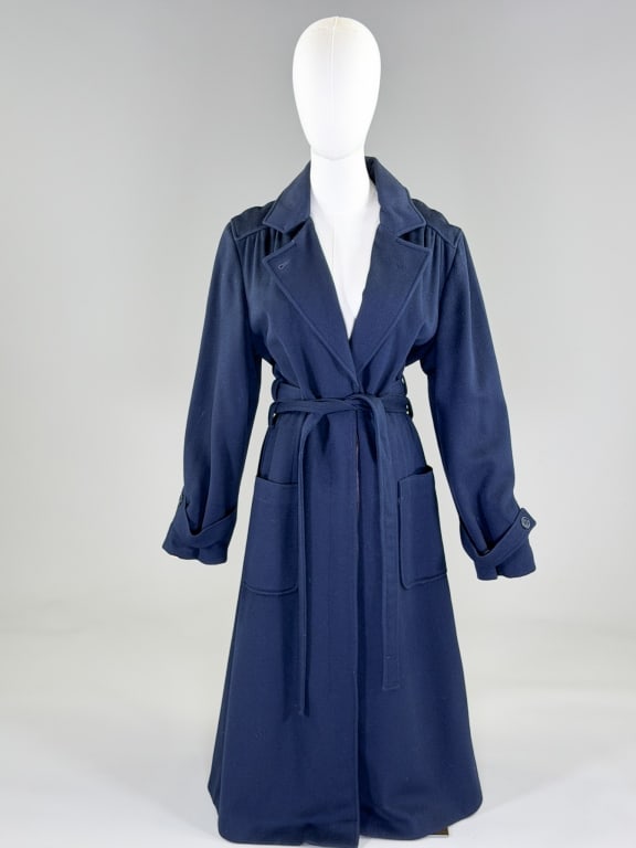 Vintage 1980s Navy Blue Wool Overcoat Jacket: Vintage 1980s Navy Blue Wool Overcoat Jacket having notched lapel collar with single breasted button front closure, two front patch pockets and belt at waist, fully lined. Measuring 42 inch bust, 34 i