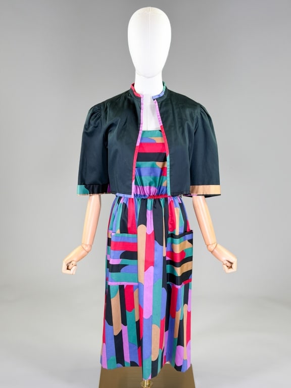 Vintage 1980s Gino Ferrari Cotton Print Dress Set: Vintage 1980s Gino Ferrari Cotton Print Dress Set having cropped open front bolero jacket measuring 15 inches long, 14 inch sleeve length. Dress having elastic waist and back zip closure measuring 34 