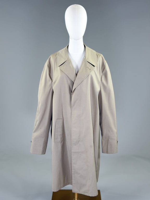 Vintage 1980s Beige Trench Rain Coat Jacket: Vintage 1980s Beige Trench Rain Coat Jacket having notch lapel collar with covered single breasted button placket closure and two front pockets, fully lined. Measuring 50 inch chest, 41 inches long, 2