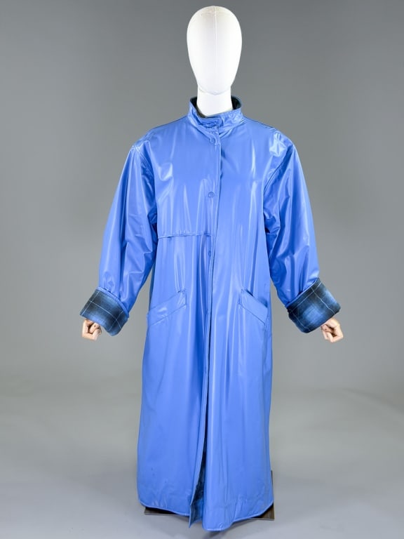 Vintage 1980s Misty Harbor PVC Rain Jacket: Vintage 1980s Misty Harbor PVC Rain Jacket having snap front closure with two front pockets, fleece lined throughout. Labeled Misty Harbor. Measuring 48 inch chest, 48 inches long, 24 inch sleeve leng