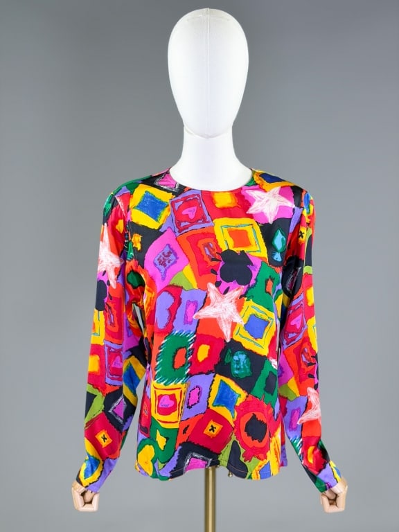 Vintage 1980s Emanuel Ungaro Satin Printed Blouse: Vintage 1980s Emanuel Ungaro Satin Printed Blouse having patchwork print throughout with back neck button closure. Labeled Emanuel, Emanual Ungaro, marked size 4/38. Measuring 40 inch bust, 24 inches