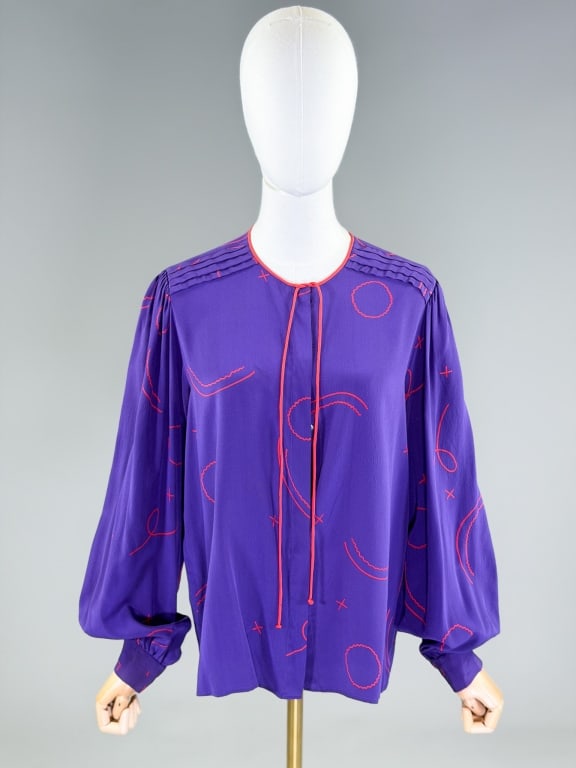 Vintage 1980s Zandra Rhodes Silk Blouse Top Shirt: Vintage 1980s Zandra Rhodes Silk Blouse Top Shirt having covered placket button front closure and tie at neck. Labeled Zandra Rhodes London, marked size 12. Measuring 40 inch bust, 26 inches long, 26 