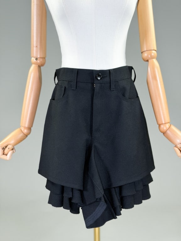 Junya Watanabe 2011 Black Wool Ruffled Short Skirt: Junya Watanabe 2011 Black Wool Ruffled Short Skirt having zip front closure and classic five pocket style. Labeled Junya Watanabe Comme de Garcons, marked size Small. Measuring 28 inch waist, 19 inch
