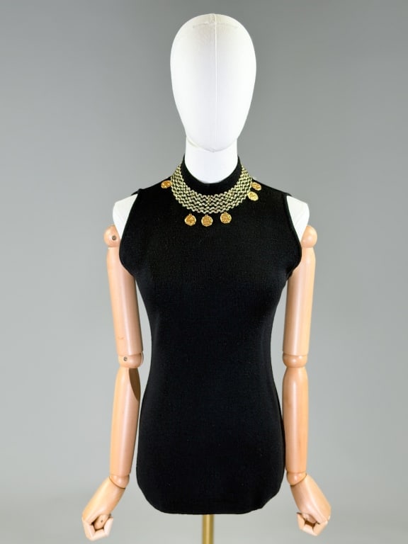 Vintage Knit Sleeveless Coin Embellished Tank Top: Vintage Knit Sleeveless Coin Embellished Tank Top having embellishments at neck with back neck button closure and stretch throughout. Measuring 34 - 44 inch bust, 26 inches long. Missing coin as shown