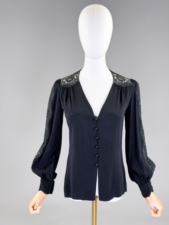 Vintage Christian Aujard Paris Lace Button Blouse: Vintage Christian Aujard Paris Lace Button Front Blouse having v-neckline with button front closure and lace details throughout. Labeled Christian Aujard Paris. Measuring 34 inch bust, 30 inch waist, 