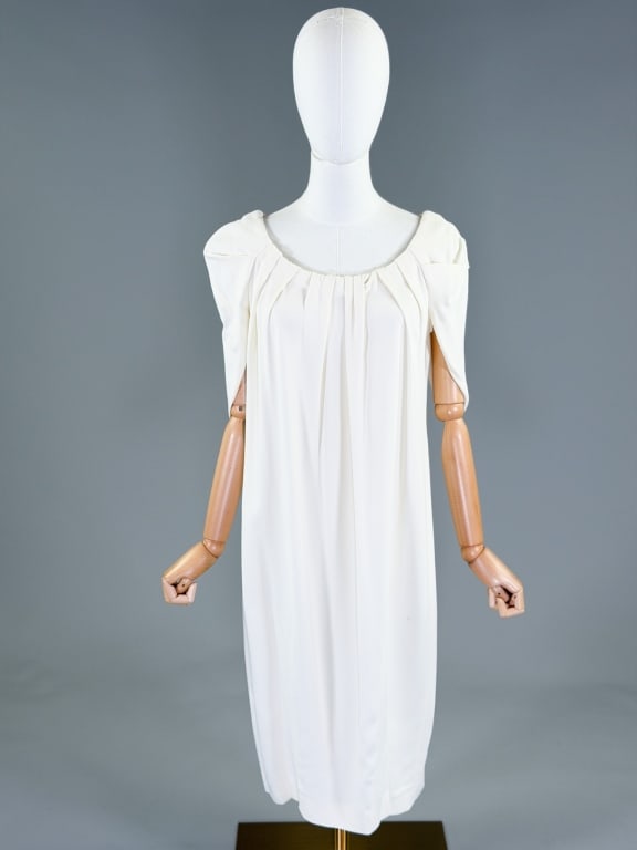 Vionnet Paris White Rayon Crepe Dress: Vionnet Paris White Rayon Crepe Dress having caped detail at shoulders with pleating throughout. Labeled Vionnet Paris. Measuring 36-44 inch bust, free waist, 40 inches long, 13 inch sleeve length. Ge