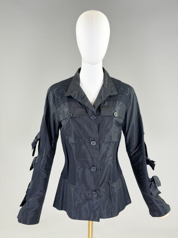 Uli Schneider Silk Felt Wool Blazer Jacket: Uli Schneider Silk Felt Wool Blazer Jacket having button front closure with two breast pockets and tie details down sleeves. Measuring 38 inch bust, 34 inch waist, 26 inches long, 24 inch sleeve lengt