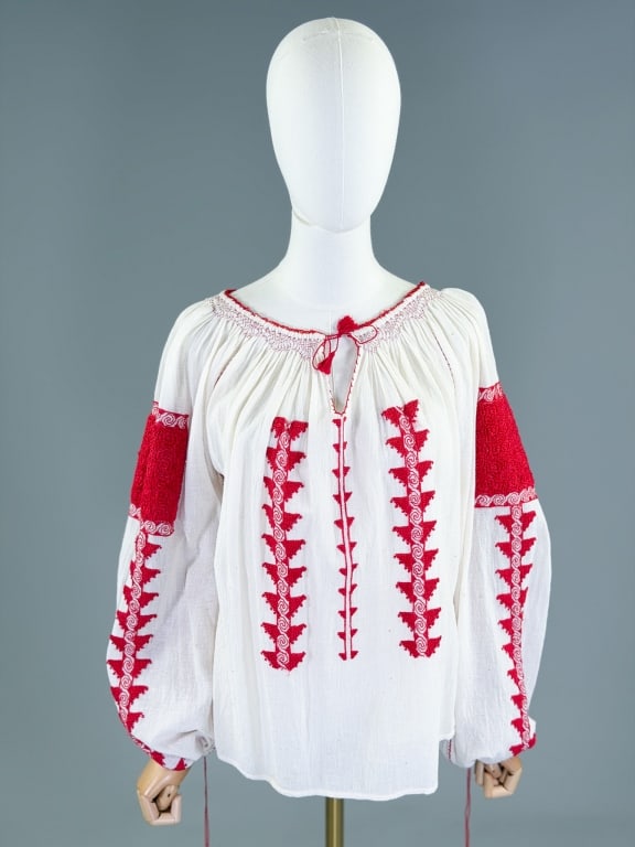 Vintage Red Embroidered Gauze Peasant Folk Blouse: Vintage Red Embroidered Gauze Peasant Folk Blouse having tie at neck and sleeve cuffs with embroidery throughout. Measuring free bust, 23 inches long, 25 inch sleeve length. From the lifetime