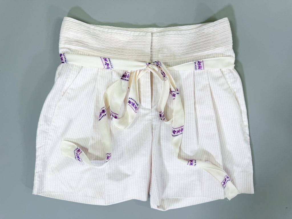 Vintage 2000s Roberto Cavalli Stripe Cotton Shorts: Vintage 2000s Roberto Cavalli Stripe Cotton Shorts having zip front closure with attached silk tie at waist. Marked size 38. Measuring 30 inch waist, 11.5 inch rise, 5 inch inseam. From the lifetime c