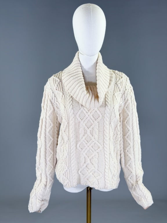 Vintage 2000s Paul James Wool Cable Knit Sweater: Vintage 2000s Paul James Wool Cable Knit Sweater Top having cowl turtleneck and stretch throughout. Marked size Large. Measuring 42-56 inch bust, 24 inches long, 24 inch sleeve length. General wear as