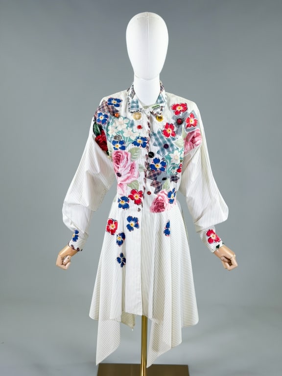 Flower Power Patchwork Reworked Button Up Top: Flower Power Patchwork Reworked Button Up Top having patchwork floral and button embellishments throughout. Measuring 36 inch bust, 28 inch waist, 44 inches long, 21 inch sleeve length. From the