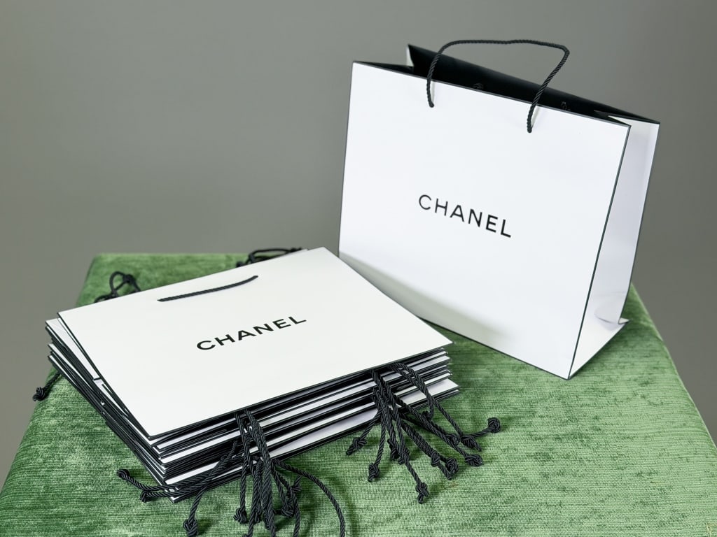 Collection of 12 Chanel Paris Shopping Bags: Collection of 12 Chanel Paris Shopping Bags. Measuring approximately 12 inches by 10 inches. From the lifetime collection, fashion archive and business inventory of collector and dealer Elaine