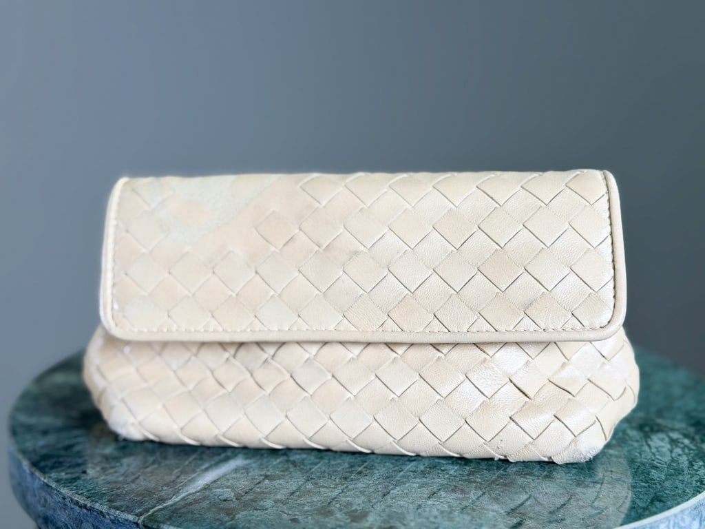 Vintage Bottega Veneta Intrecciato Leather Clutch: Vintage Bottega Veneta Intrecciato Leather Woven Clutch Bag having magnetic lock closure with snaps, woven throughout with butterfly design on back. General wear as shown throughout. Measuring approxi