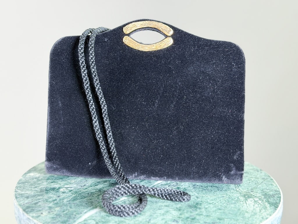 Vintage 1980s Guy Laroche Velvet Clutch Bag: Vintage 1980s Guy Laroche Velvet Clutch Bag having magnetic lock closure with corded strap. Measuring approximately 7 inches high by 8 inches wide by 1 inch deep. From the lifetime collection, fashion