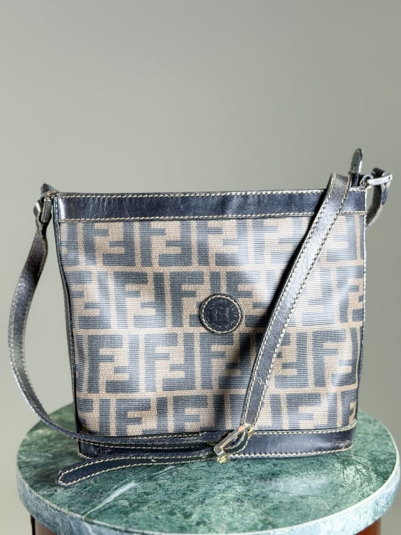 Vintage Fendi Canvas Zucca Print Bucket Bag: Vintage Fendi Zucca Print Bucket Bag having zip top closure and print throughout. Measuring approximately 7.5 inches high by 9 inches wide by 3 inches deep. General wear as shown throughout. From the 