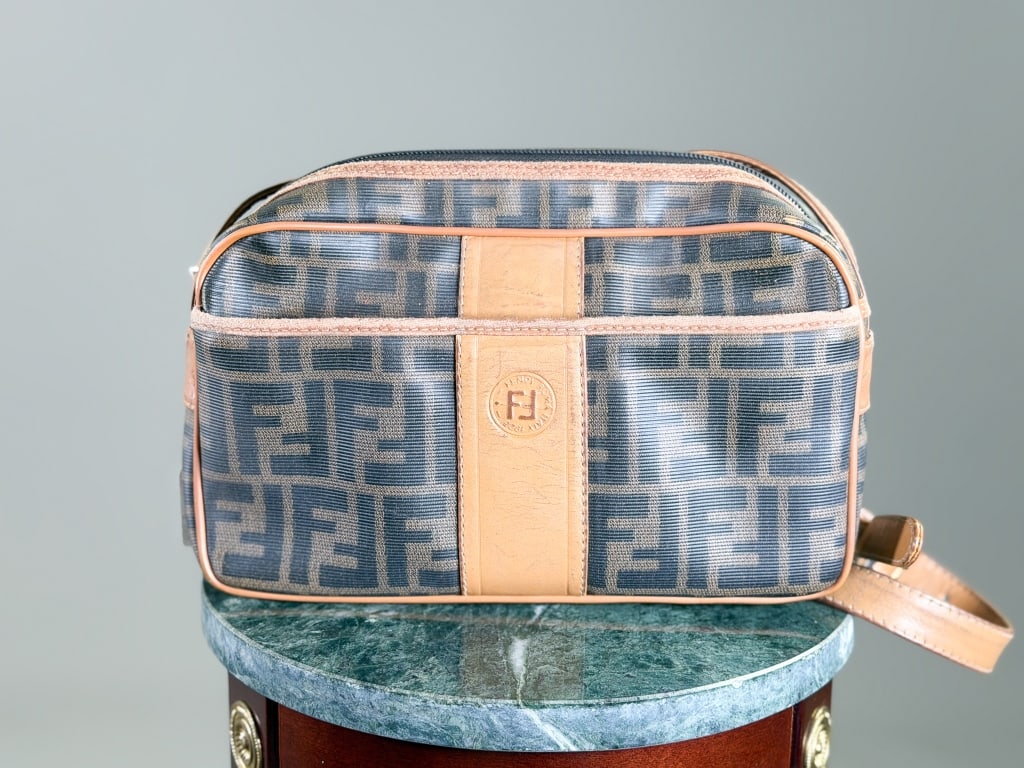 Vintage Fendi Canvas Zucca Print Crossbody Bag: Vintage Fendi Zucca Print Crossbody Bag having zip top closure and front zip pocket. Measuring approximately 6.5 inches high by 10 inches wide by 3 inches deep. From the lifetime collection, fashion a