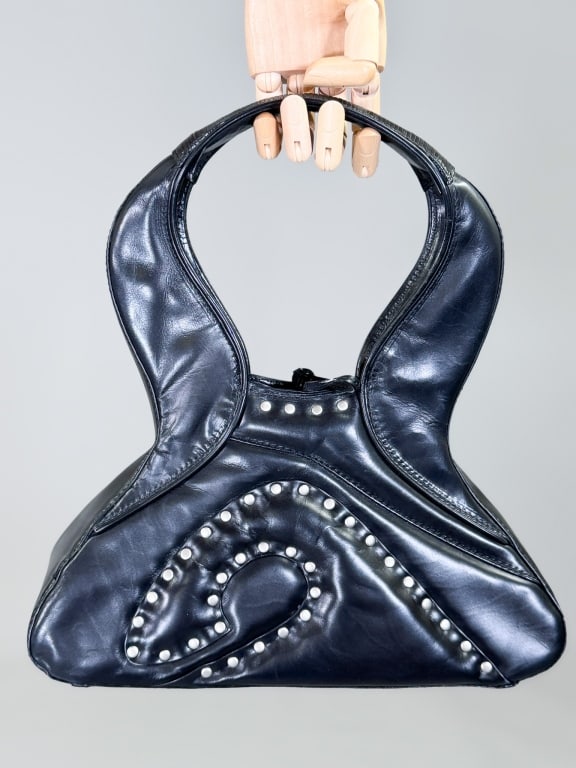 Vintage 2000s Issey Miyake Studded Pleather Purse: Vintage 2000s Issey Miyake Studded Pleather Purse Bag having studded details throughout with top handle and tie closure. Measuring approximately 7 inches high by 12 inches wide by 4 inches deep. From 