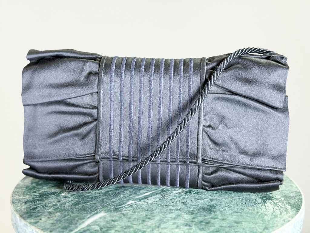 Vintage Fendi Silk Satin Bow Clutch Purse: Vintage Fendi Silk Satin Bow Clutch Purse having magnetic snap lock closure with removable strap. Measuring approximately 5 inches high by 10 inches wide by 2 inches deep. From the lifetime collection