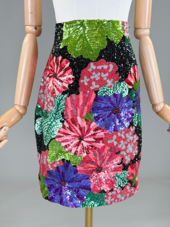 Vintage 1990s Todd Oldham Floral Embellished Skirt: Vintage 1990s Todd Oldham Floral Embellished Skirt having dense glass bead and sequin floral embellishments throughout with side zip closure. Labeled Todd Oldham. Measuring 28 inch waist, 20 inches lo