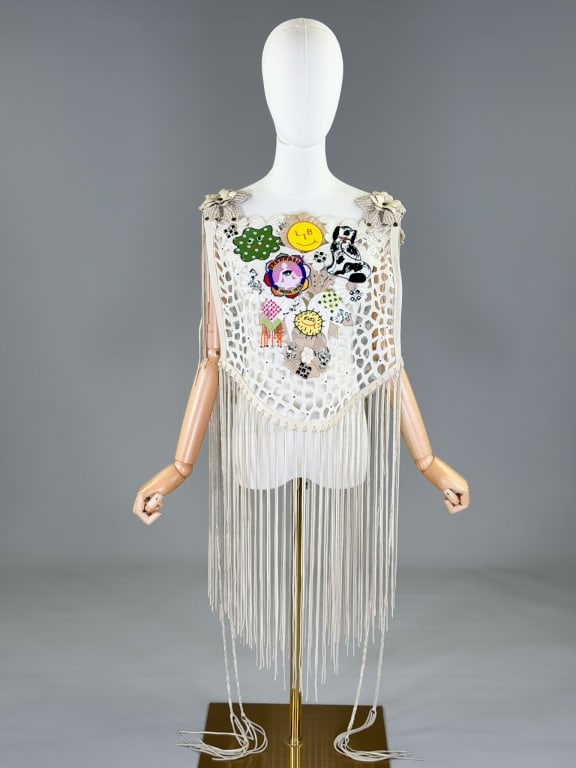 Libertine Leather Fringe Floral Patch Hippy Top: Libertine Leather Fringe Floral Patch Hippy Top having embellished patches at front with fringed edges and floral detail at shoulders. Labeled Libertine. Open at sides, measuring one size fits most, a
