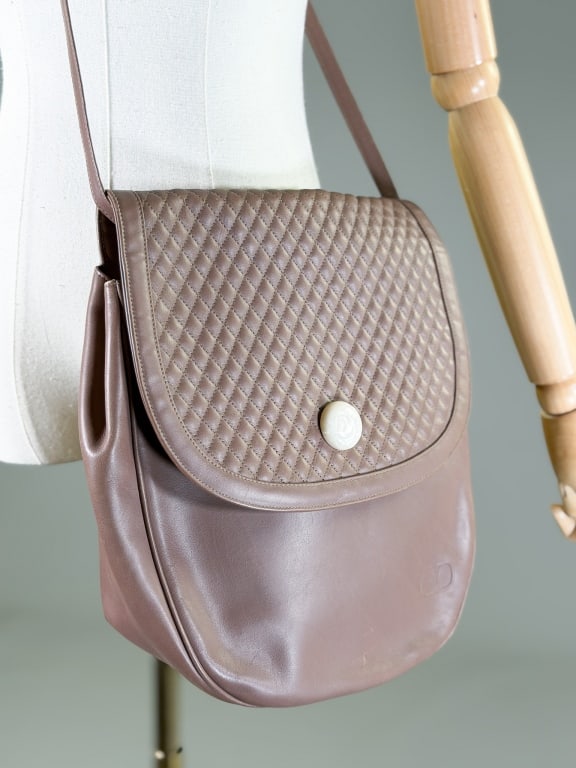Vintage 1980s Valentino Leather Quilted Purse Bag: Vintage 1980s Valentino Leather Quilted Purse Bag having magnetic snap closure with removable strap. Measuring approximately 13 inches high by 10 inches wide by 4 inches deep. From the lifetime collec