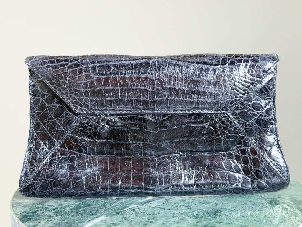 Vintage Nancy Gonzalez Crocodile Leather Bag: Vintage Nancy Gonzalez Crocodile Leather Clutch Bag having magnetic snap lock closure. Measuring approximately 5 inches high by 9 inches wide by 2 inches deep. From the lifetime collection, fashion ar