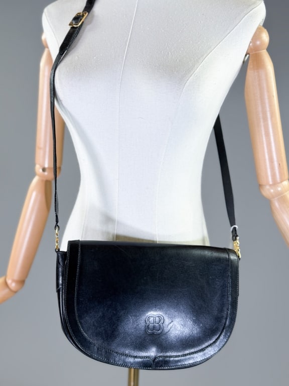 Vintage 1970s Balenciaga Leather Crossbody Bag: Vintage 1970s Balenciaga Leather Crossbody Bag having magnetic snap closure at front with adjustable cross body strap. Measuring approximately 7 inches high by 10 inches wide by 3 inches deep. From th