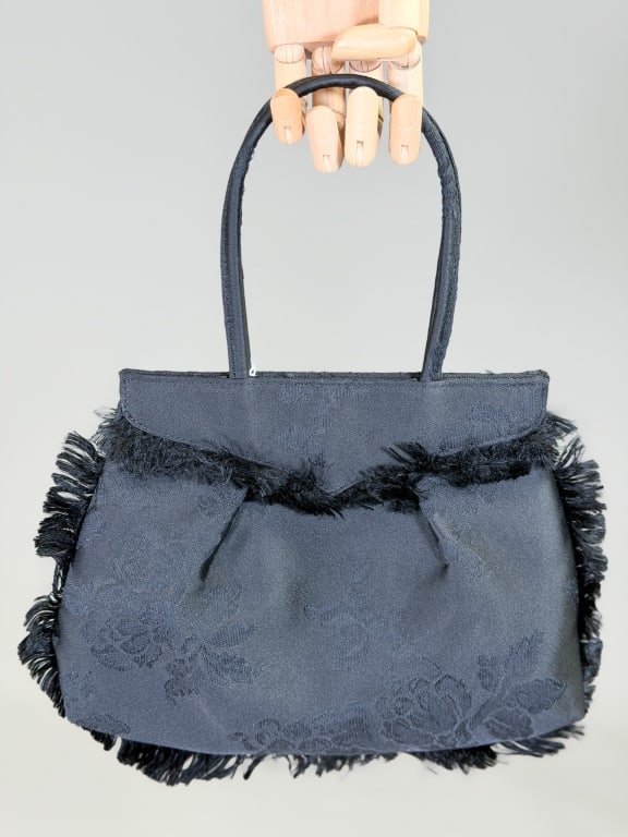 Vintage 1990s Vivienne Westwood Silk Brocade Purse: Vintage 1990s Vivienne Westwood Silk Brocade Purse Bag having magnetic snap closure, fringe edges and top handles. Measuring approximately 8 inches high by 11 inches wide by 2 inches deep. From the li