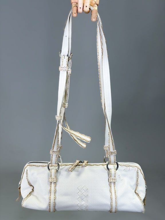 Vintage 2000s Bottega Veneta Laser Cut Leather Bag: Vintage 2000s Bottega Veneta Laser Cut Leather Bag Purse having zip top closure with adjustable shoulder straps. Measuring approximately 6 inches high by 13 inches wide by 5 inches deep. General wear 