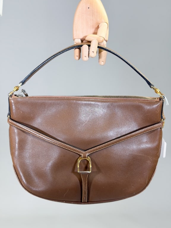 Vintage 1970s Gucci Leather Hobo Purse Bag: Vintage 1970s Gucci Leather Hobo Purse Bag having zip top closure with horse-bit detail at front. Measuring approximately 9.5 inches high by 13 inches wide by 2 inches deep. From the lifetime collecti