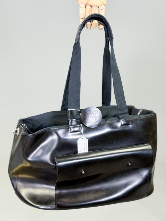 Vintage 1990s Jean Paul Gaultier Leather Tote Bag: Vintage 1990s Jean Paul Gaultier Leather Tote Bag having zip top closure with shoulder straps. Measuring approximately 10 inches high by 16 inches wide by 12 inches deep. General wear as shown through