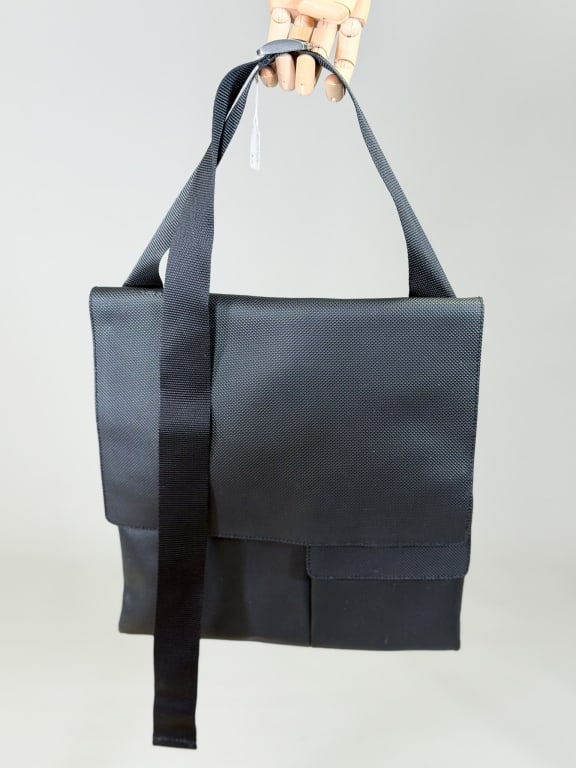 Vintage 2000s Bottega Veneta Vinyl Messenger Bag: Vintage 2000s Bottega Veneta Vinyl Messenger Bag having flap closure with pockets throughout and adjustable shoulder strap. Measuring approximately 13 inches high by 12 inches wide. From the lifetime 