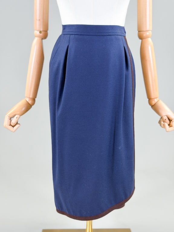 Vintage 1980s Yves Saint Laurent Wool Wrap Skirt: Vintage 1980s Yves Saint Laurent Wool Wrap Skirt having hook closure at waist. Marked size 36. Measuring 24 inch waist, 27 inches long. From the lifetime collection, fashion archive and business inven