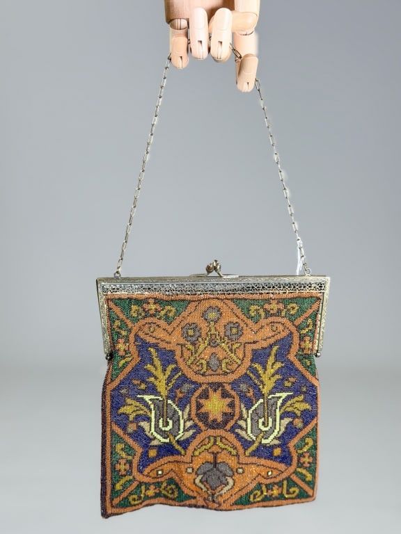 Antique 1920s Beaded Floral Evening Bag: Antique 1920s Beaded Floral Evening Bag having metal frame kiss lock closure with chain strap. Measuring approximately 8 inches by 8 inches. From the lifetime collection, fashion archive and business 
