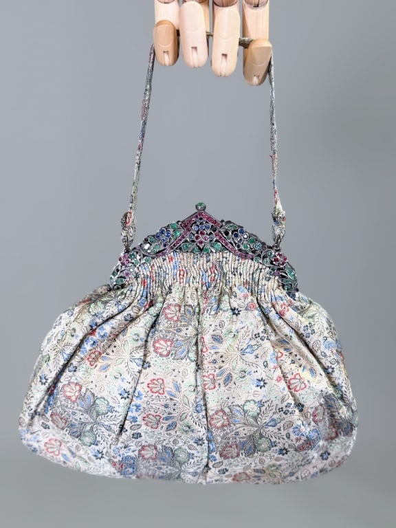 Antique 1920s Lame Floral Brocade Rhinestone Purse: Antique 1920s Lame Floral Brocade Rhinestone Purse Bag having metal frame closure with paste set stones and interior pockets. Measuring approximately 7 inches high by 8 inches wide by 2.5 inches deep.