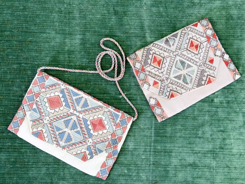Pair of Vintage 1930s Embroidered Pouch Bag Purses: Pair of Vintage 1930s Embroidered Pouch Bag Purses. One with zippered closure and one with braided strap. Larger measuring 9 inches by 6 inches. From the lifetime collection, fashion archive and busin