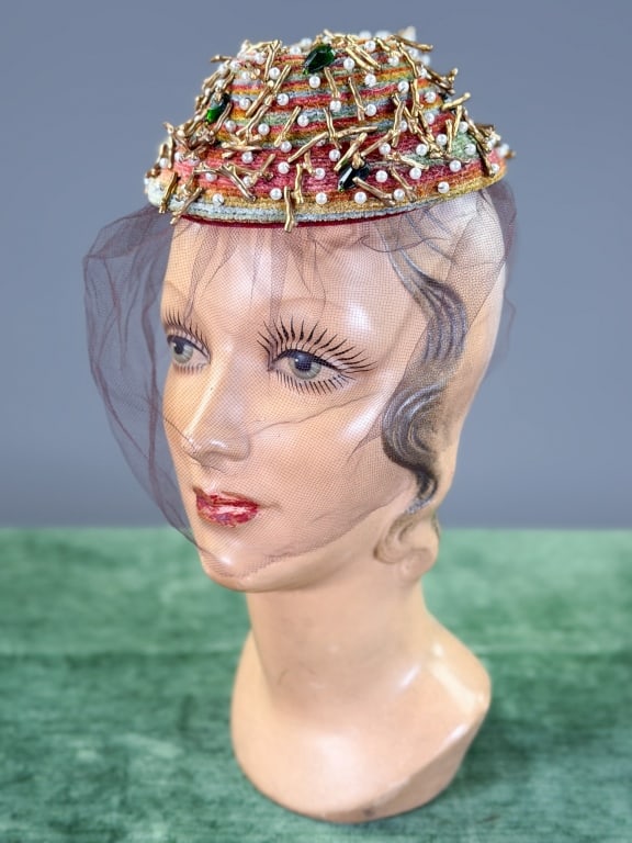 Vintage 1950s Chenille Embellished Fascinator Hat: Vintage 1950s Chenille Embellished Fascinator Hat having embellishments throughout with net detail. Labeled Chanda. Interior circumference measuring approximately 17.5 inches. From the lifetime collec
