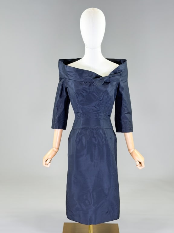 Vintage 1960s Silk Bow Cocktail Dress: Vintage 1960s Silk Bow Cocktail Dress having center back zip closure. Measuring 36 inch bust, 26 inch waist, 40 inches long, 18 inch sleeve length. General wear throughout as show. From the lifetime c