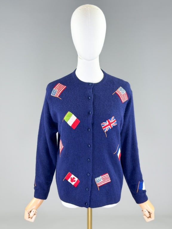 Vintage 1960s Embroidered flag Cardigan Sweater: Vintage 1960s Embroidered flag Cardigan Sweater having button front closure and embroidery throughout. Marked size 42. Measuring 40-46 inch bust, 34-42 inch waist, 23 inches long, 20 inch sleeve lengt