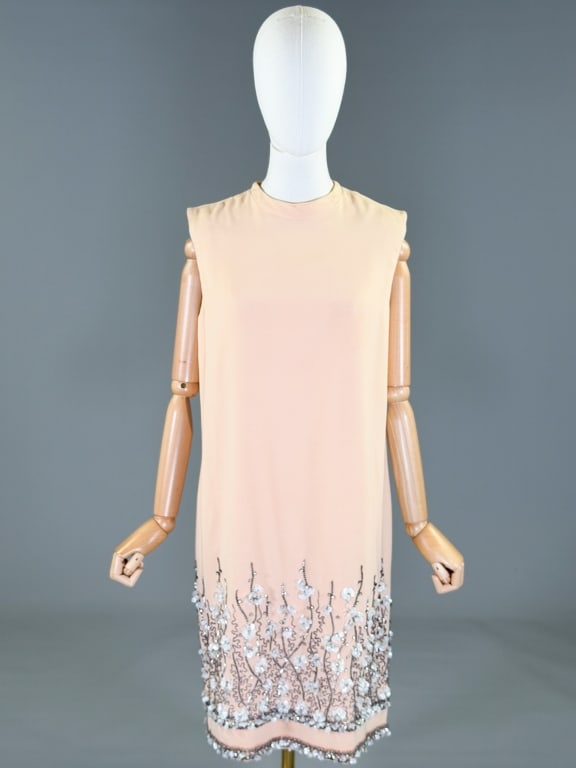 Vintage 1960s Crepe Beaded Shift Dress: Vintage 1960s Crepe Beaded Shift Dress having center back zip closure and beading at hem. Marked size 12. Measuring 38 inch bust, 38 inches long. General wear as shown throughout. From the lifetime co