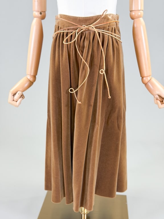 Vintage 1970s Velour Leather Tie Midi Skirt: Vintage 1970s Velour Leather Tie Midi Skirt having leather tie at waist with back zip closure. Measuring 26 inch waist, 28 inches long. General wear as shown throughout. From the lifetime collection, 