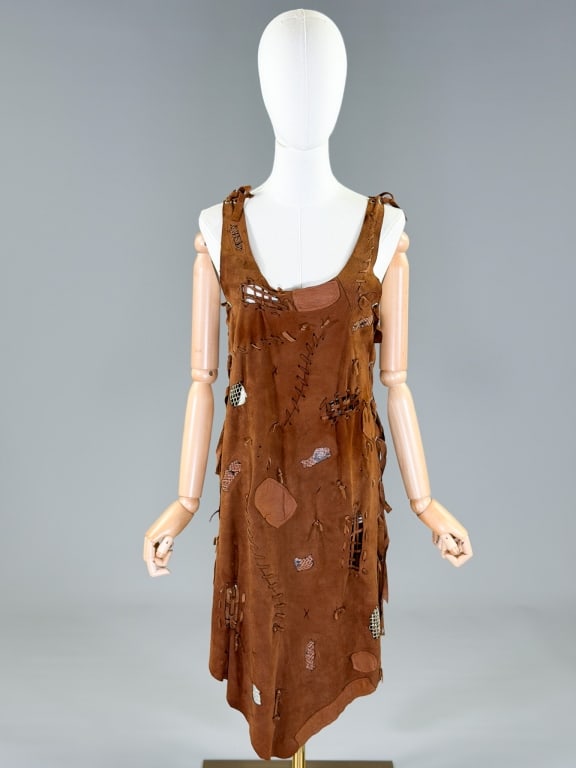 Vintage 1970s Leather Stitched Patchwork Dress: Vintage 1970s Leather Stitched Patchwork Dress having lace up closure at side seams, adjustable throughout. Measuring approximately 43 inches long. General wear as shown throughout. From the lifetime 