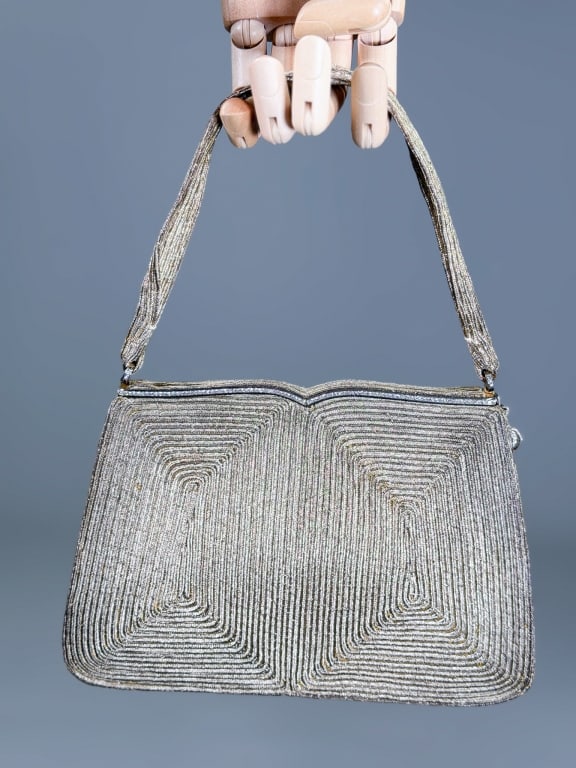 Vintage 1950s Lame Corded Evening Bag: Vintage 1950s Lame Corded Evening Bag having metal frame lock closure with interior pockets. Measuring approximately 5.5 inches wide by 8 inches wide by 2.5 inches deep. From the lifetime collection, 