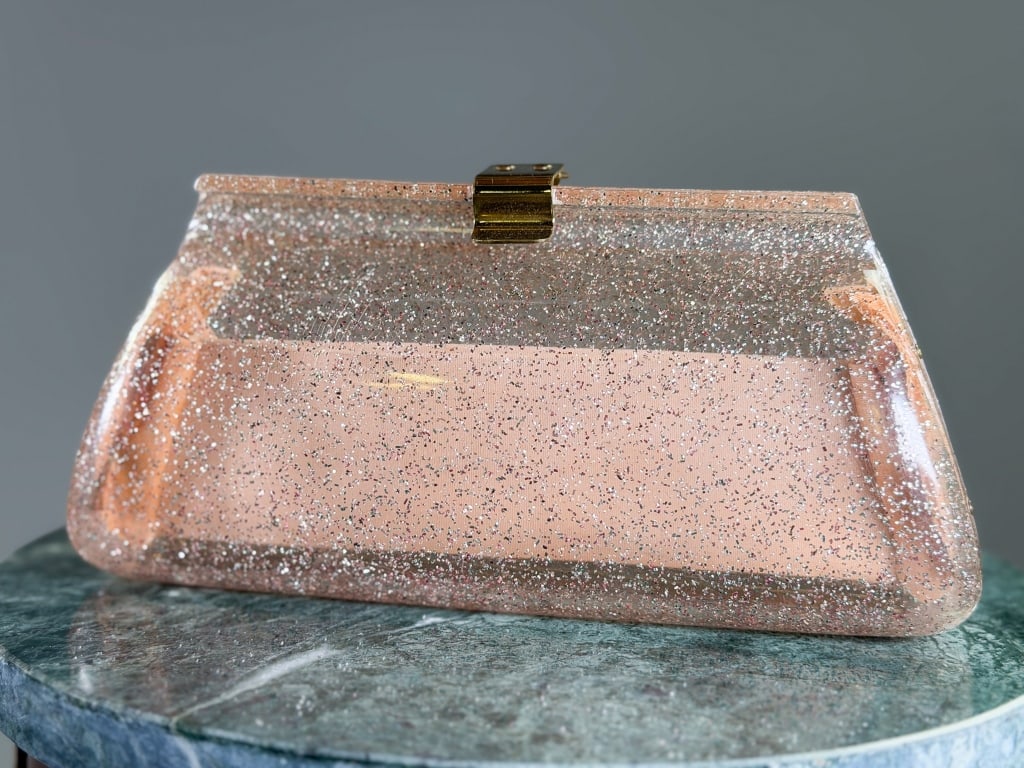 Vintage 1960s Glitter Lucite Clutch Bag: Vintage 1960s Glitter Lucite Clutch Bag having lock closure at top with interior pocket. Measuring approximately 4 inches high by 9 inches wide by 2 inches deep. From the lifetime collection, fashion 