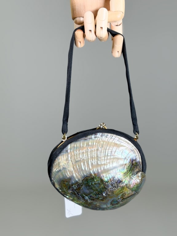 Vintage 1960s Satin Abalone Shell Evening Bag: Vintage 1960s Satin Abalone Shell Evening Bag having metal frame kiss lock closure with mirrored interior and cosmetic pockets. Measuring approximately 5 inches high by 6 inches wide by 2 inches deep.