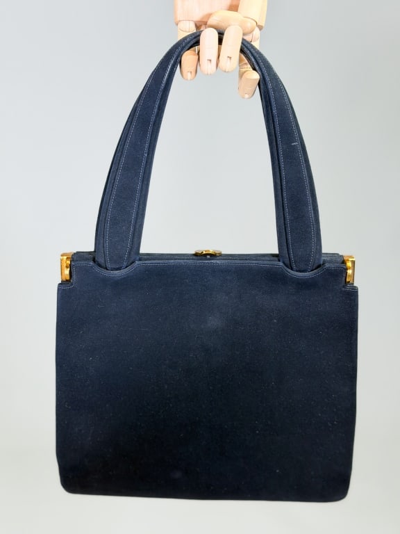 Vintage 1960s Suede Leather Purse Bag: Vintage 1960s Suede Leather Purse Bag having metal frame closure with top handle. Measuring approximately 10 inches high by 11 inches wide by 2 inches deep. From the lifetime collection, fashion archi