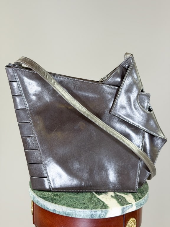 Vintage 1980s Leather Shoulder Bag: Vintage 1980s Leather Shoulder Bag having zip top and snap front closures. Measuring approximately 14 inches high by 12 inches wide by 2 inches deep. From the lifetime collection, fashion archive and 